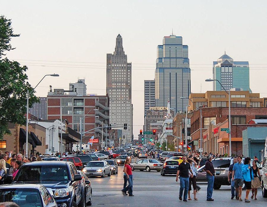 The Wade A bustling city street filled with pedestrians and vehicles, showcasing the vibrant energy of urban life.