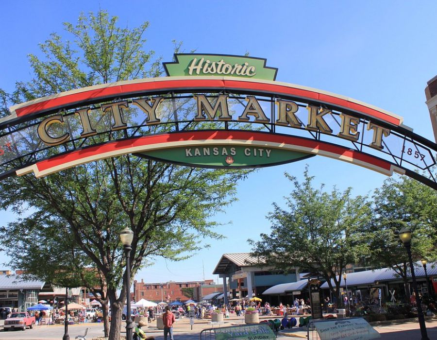 The Wade A city market sign displayed prominently in front of a building, indicating a vibrant marketplace atmosphere.